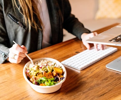 Young Professional Female eating lunch at her office