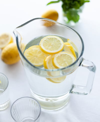 A pitcher of water with lemon